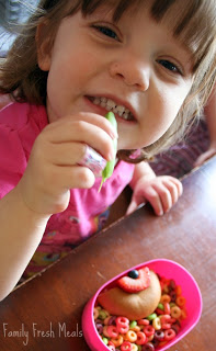 child sitting at a table eating Somewhere Over The Rainbow Lunchbox