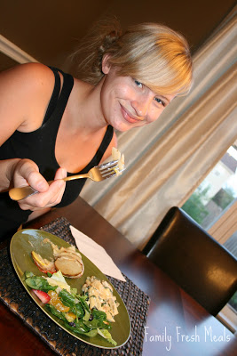 woman sitting at a table eating the Vegetable Pie 