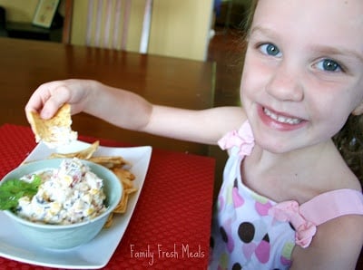 girl sitting at a table eating Ranch Fiesta Dip