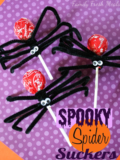 3 Suckers spider crafts on a purple piece of paper