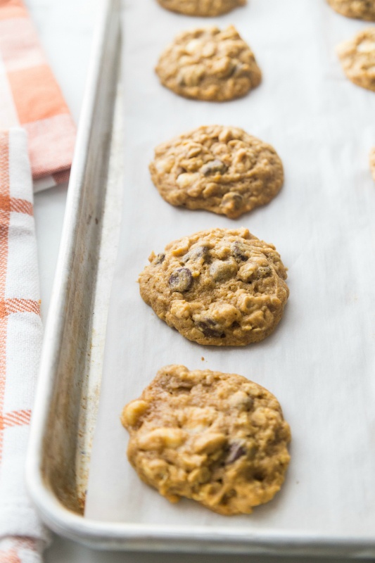 Pumpkin Oatmeal DOUBLE Chocolate Chip Cookies on baking sheet that is lined with parchment paper