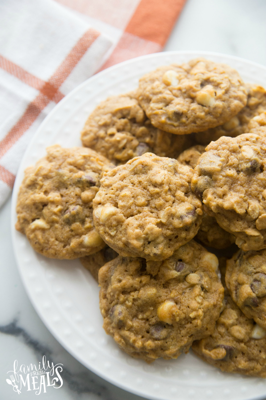 Pumpkin Oatmeal DOUBLE Chocolate Chip Cookies stacked on a white plate