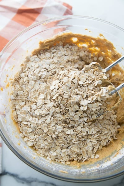 mixing oats into the batter in the mixing bowl