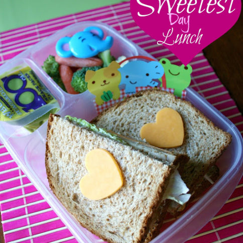 Sandwich with cheese hearts on top of bread, in a lunchbox