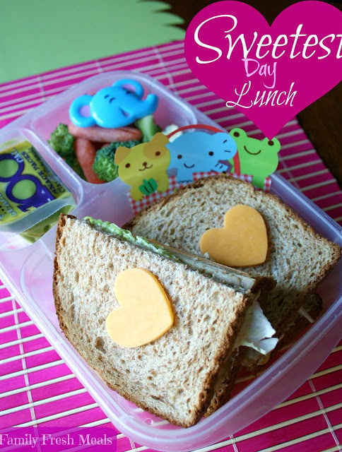 Sandwich with cheese hearts on top of bread, in a lunchbox