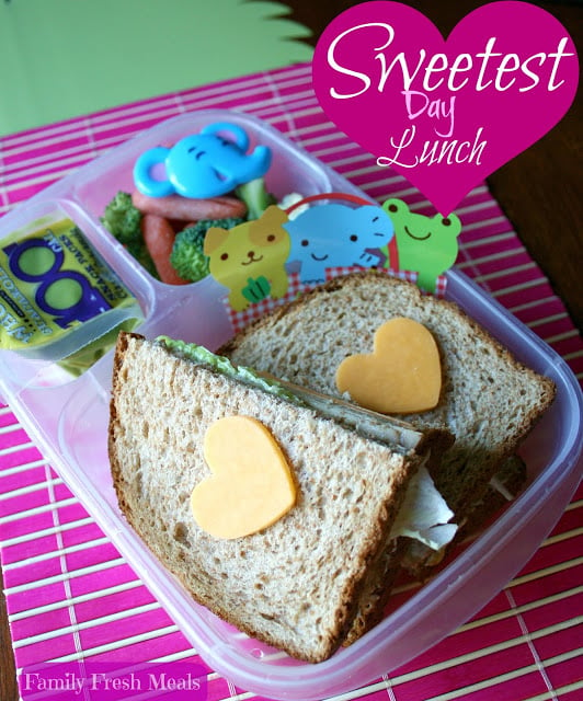 Sandwich with cheese hearts on top of bread, in a lunchbox