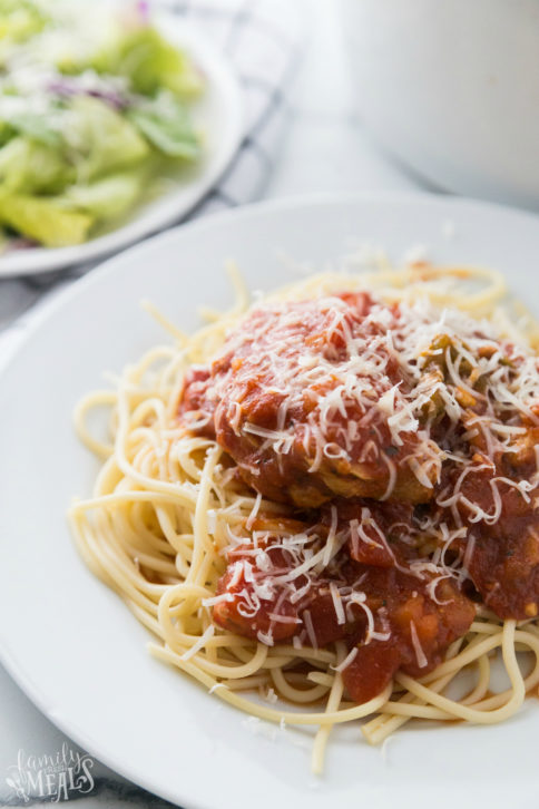 Crockpot Chicken Cacciatore served on a bed of pasta and topped with shredded cheese