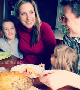woman, man and two children sitting at a table eating tater tot dip