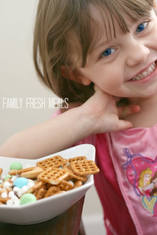 Child smiling next to a bowl of bunny bait