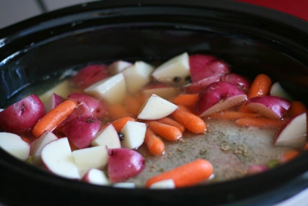 Corned Beef Slow Cooker recipe - potatoes and carrots placed in the slow cooker