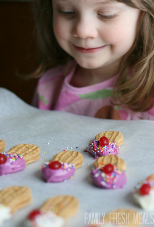 Girl sitting, smiling at Ice Cream Cookies 