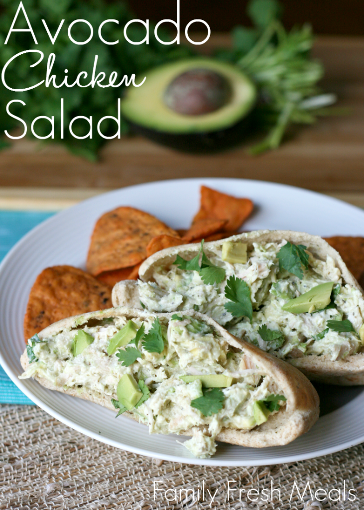 Healthy Avocado Yogurt Chicken Salad served in pita bread on a white plate with chips