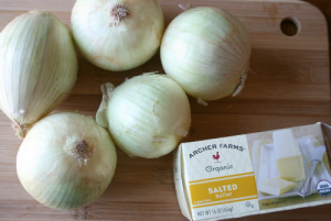 onions and pack of butter on cutting board