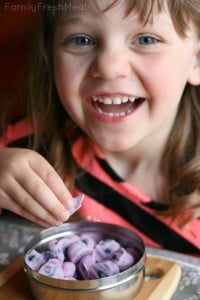 Child smile while eating Frozen Yogurt Covered Blueberries 