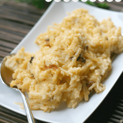 Cheesy Hash Brown Casserole served on a white plate with serving spoon