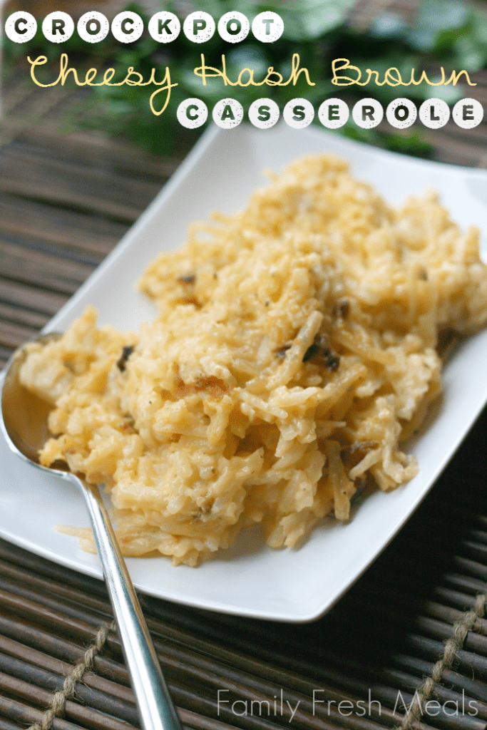 Cheesy Hash Brown Casserole on a white plate with serving spoon