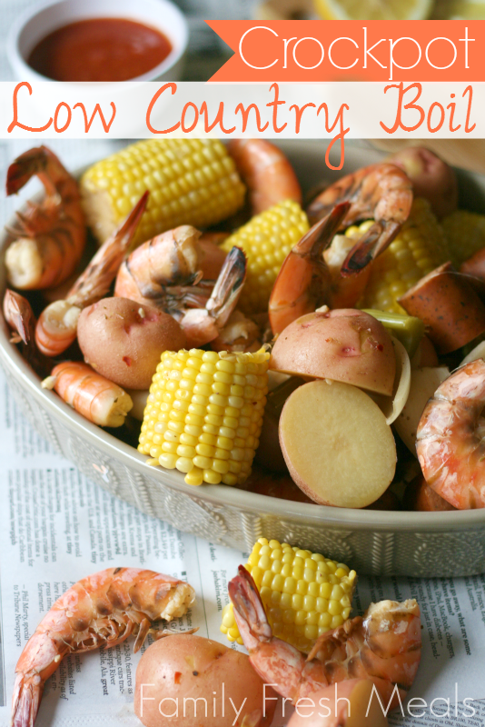 Crockpot Low Country Boil served in a grey bowl, sitting on newspaper sheets