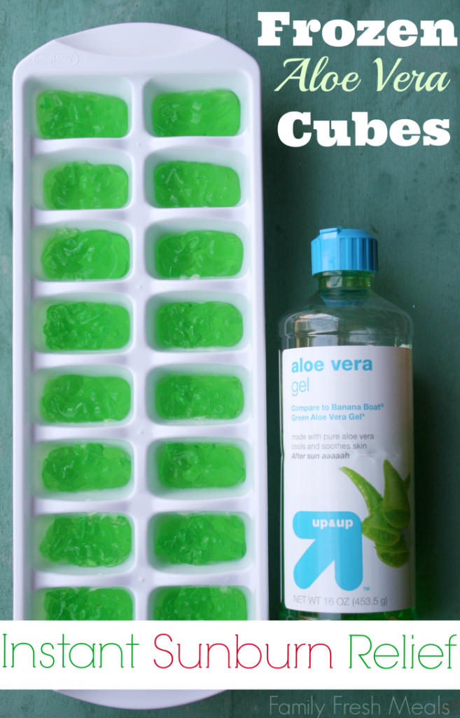 Ice cube tray filled with aloe vera gel and a bottle of aloe vera next to it