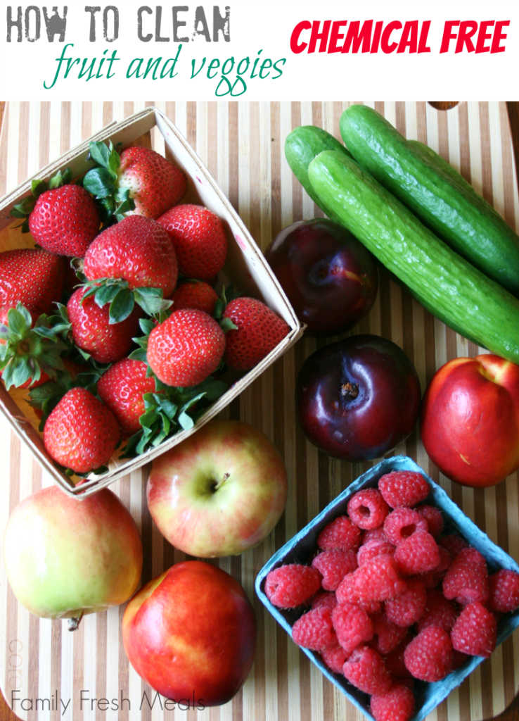 strawberries, raspberries, cucumbers, apples and plums on a cutting board