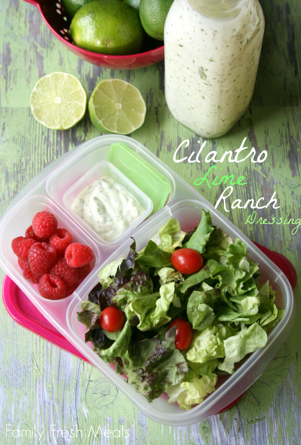 Salad, raspberries and Cilantro Lime Ranch Dressing packed in an lunchbox