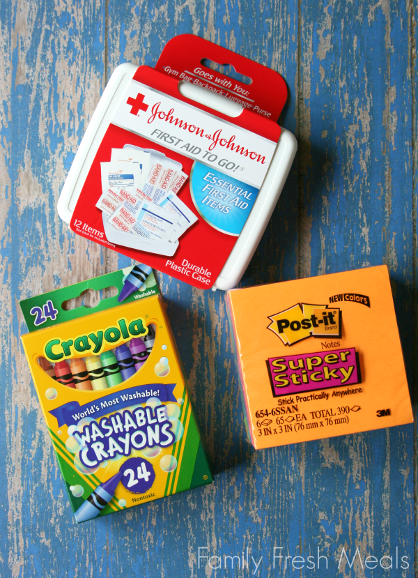 image of a box of crayons, post-it notes and a First Aid To Go.