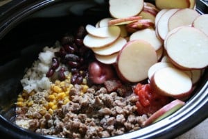Cheesy Crockpot Cowboy Casserole ingredients in a slow cooker