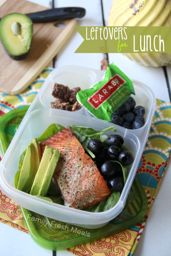 Salmon, avocado, olive, blueberries, and larabar packed in a lunchbox