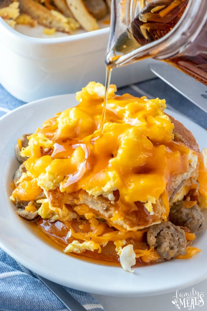 syrup being poured over a serving of Breakfast Lasagna 