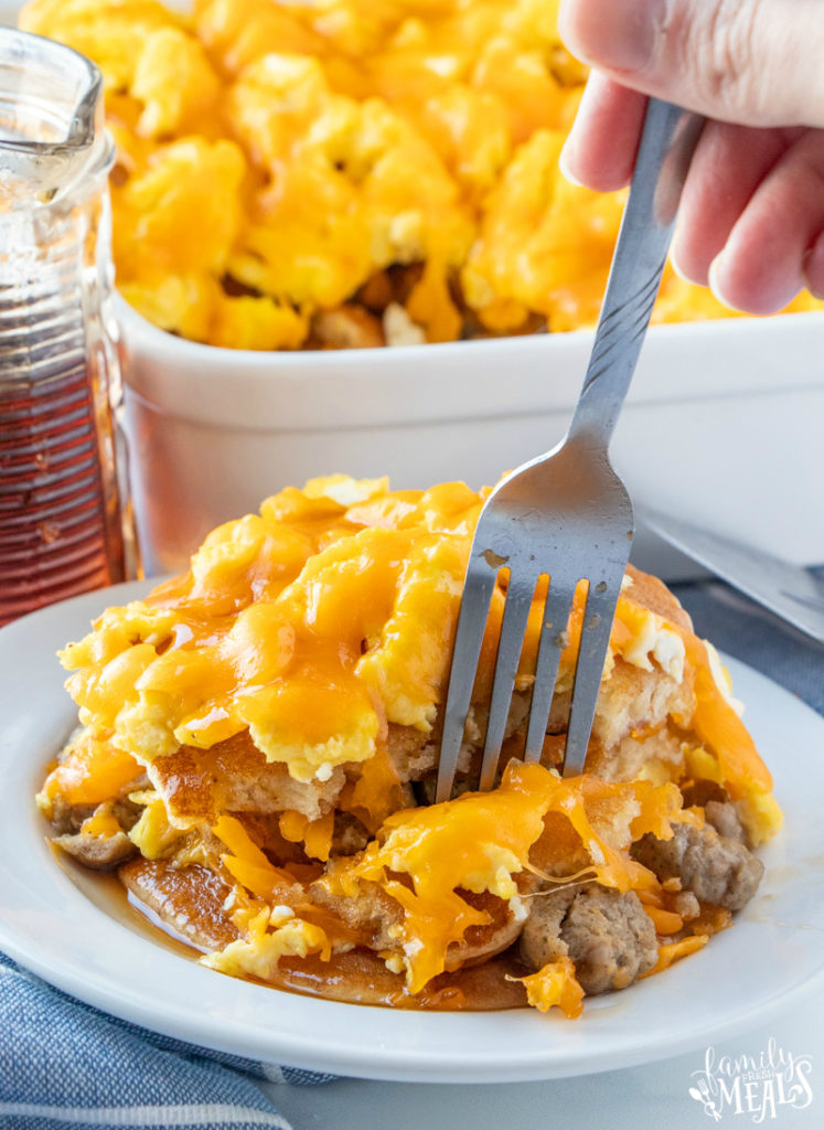 Breakfast Casserole on a white plate, with a fork picking up a piece