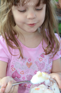 Child eating a Healthy Halloween Snack Candy Corn Fruit Parfait 