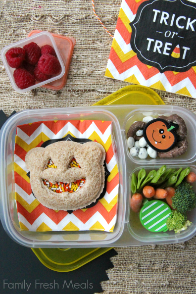 Almond butter sandwich with food sprinkles, yogurt covered raisins, pretzels, fresh veggies with some dip and raspberries. Packed in a lunchbox