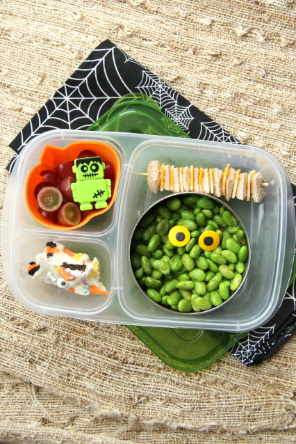 Edamame topped with candy eyes, bread and cheese bites, grapes and a piece of my super yummy Halloween Bark. Packed in a Lunchbox