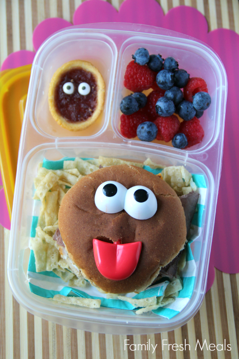 Ham and cheese sandwich, crunchy tortilla strips, fresh blueberries and strawberries, and a cookie (with candy eyes) for dessert.  Packed in a lunchbox