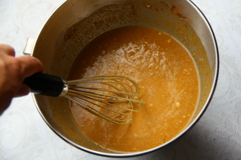 pumpkin mixture in a mixing bowl, being whisked