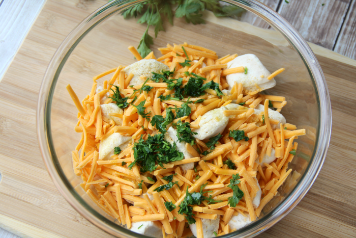 Ingredients for Cheesy Pull Apart Rolls in a glass bowl