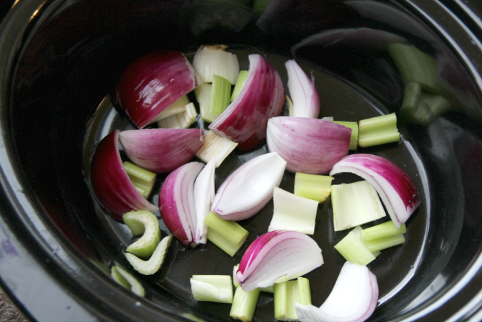 sliced red onion in a slow cooker