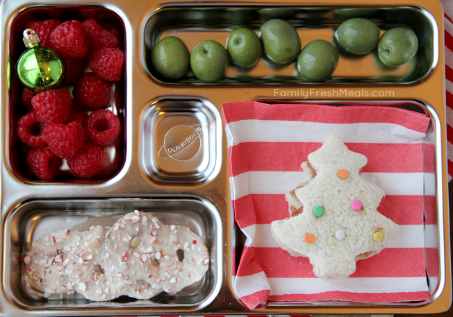 Christmas tree shaped sandwich,  olives, fresh raspberries and some chocolate covered pretzels.  Packed in a Planetbox  