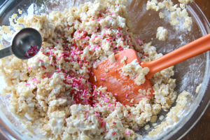 Colorful sprinkles being mixing into bowl