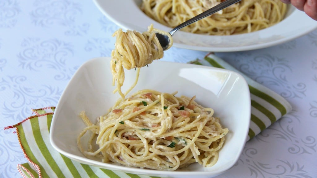 Bacon Ranch Chicken Pasta in a white bowl - with a fork with pasta twirled on it