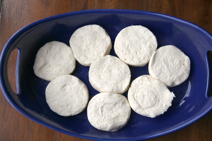 raw biscuits in a blue baking dish