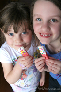 Two children holding wafer cookies