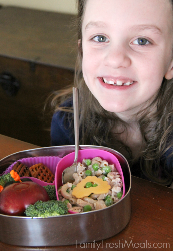 Child sitting at a table with a Valentine's day Lunchbox Ideas 