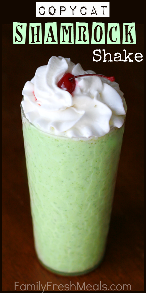 Copycat Shamrock Shake in a glass topped with whipped cream and a cherry