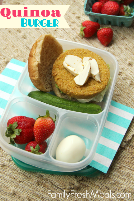 Quinoa Burger packed in a lunchbox with a cucumber, hard boiled egg and strawberries