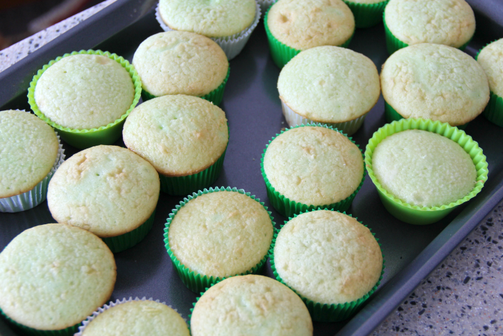 unfrosted cupcakes on a baking sheet