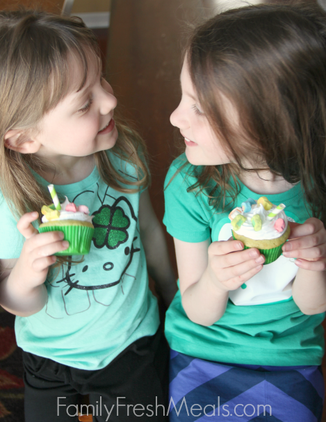two children holding Shamrock Shake Cupcakes