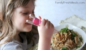 Child eating Crockpot Thai Peanut Chicken with chop sticks