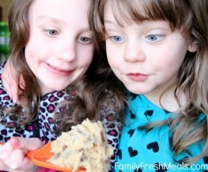 2 children looking at Edible Cookie Dough Recipe with wide eyes