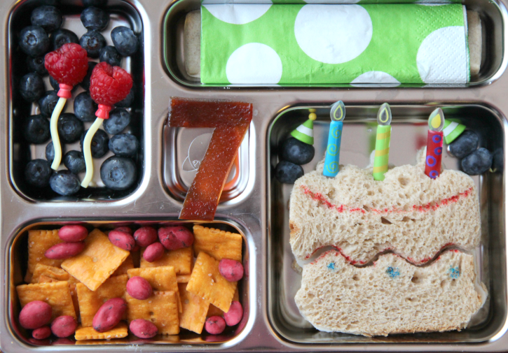 B-day cake shaped sandwich, crackers and yogurt covered raisins, fresh fruit and a fruit leather #7 - packed in a metal lunchbox 