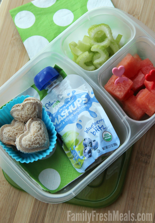 Mini heart Sandwich Pockets, celery and watermelon packed in a lunch box